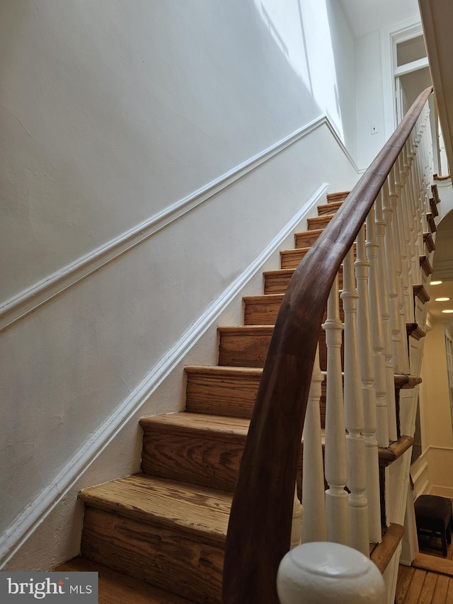 stairway with hardwood / wood-style floors