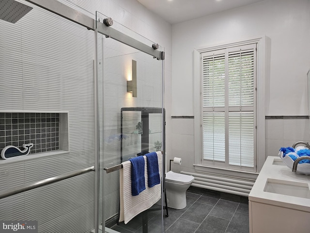 bathroom featuring tile floors, toilet, and dual bowl vanity