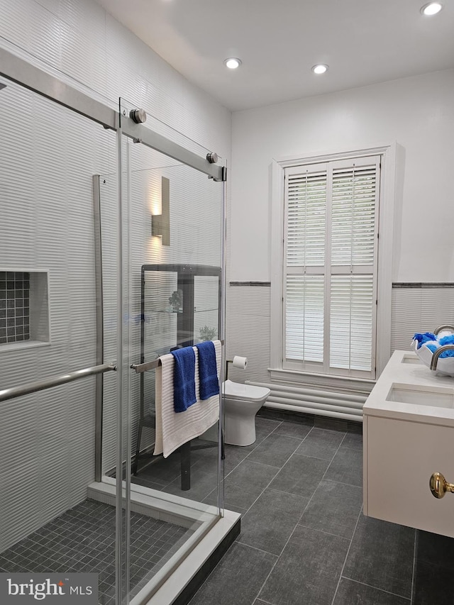 bathroom featuring tile flooring, sink, and toilet