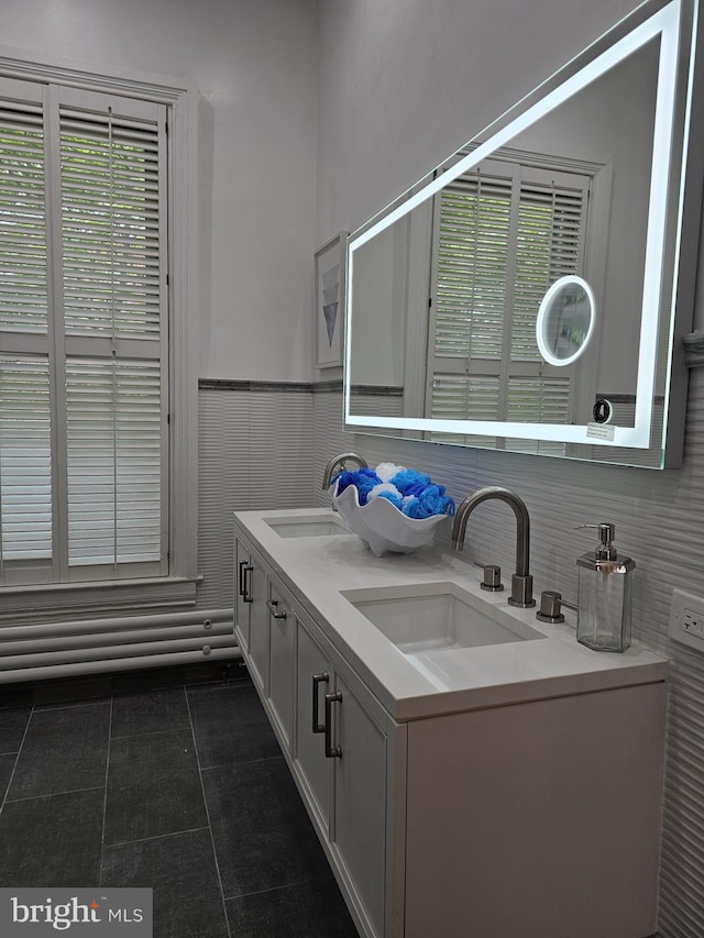 bathroom with dual sinks, tile floors, and large vanity