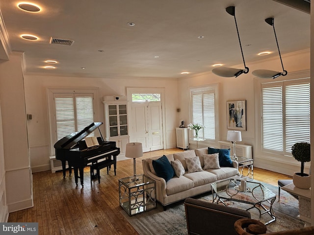 living room featuring dark hardwood / wood-style flooring and crown molding