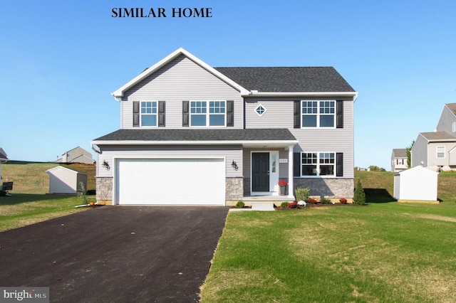 view of front of property featuring a front lawn and a garage