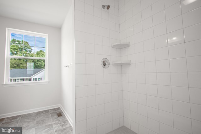 bathroom with tiled shower