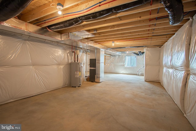 basement featuring water heater and heating unit