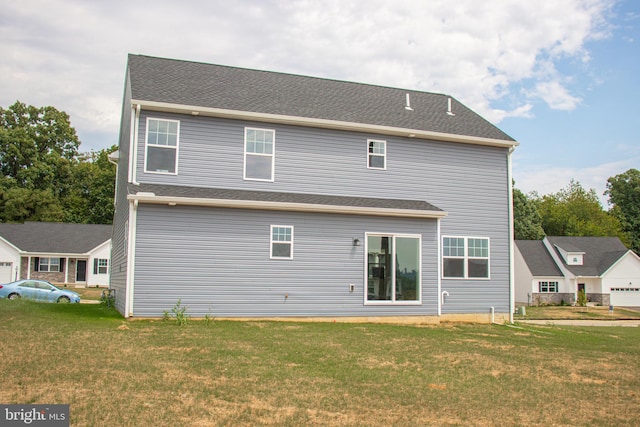 rear view of house with a lawn