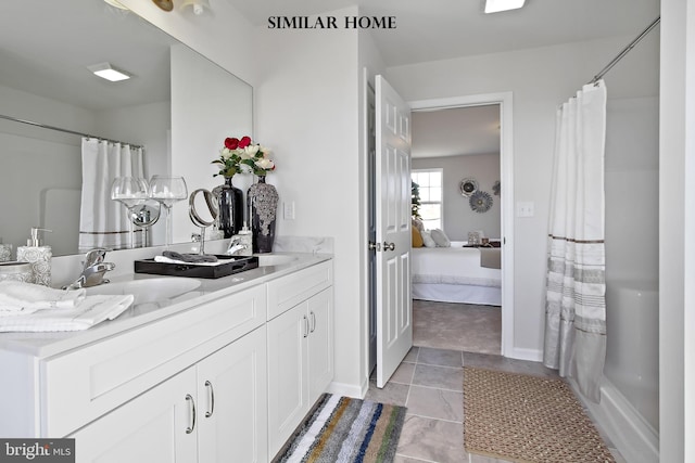 bathroom featuring vanity, curtained shower, and tile patterned flooring