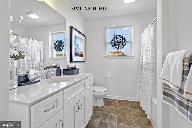 full bathroom featuring vanity, toilet, and shower / tub combo with curtain