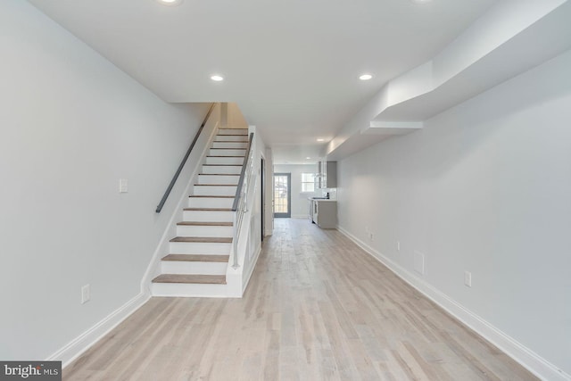 stairs with light hardwood / wood-style floors