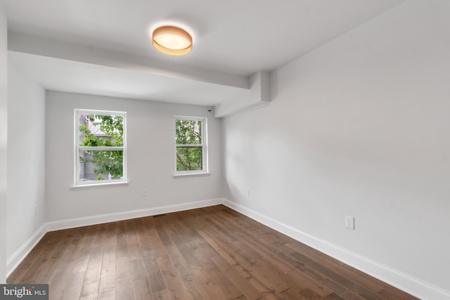 spare room with dark hardwood / wood-style floors