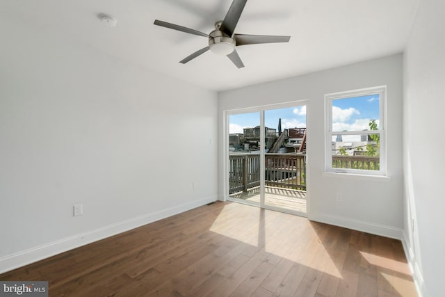 unfurnished room featuring ceiling fan and dark wood-type flooring