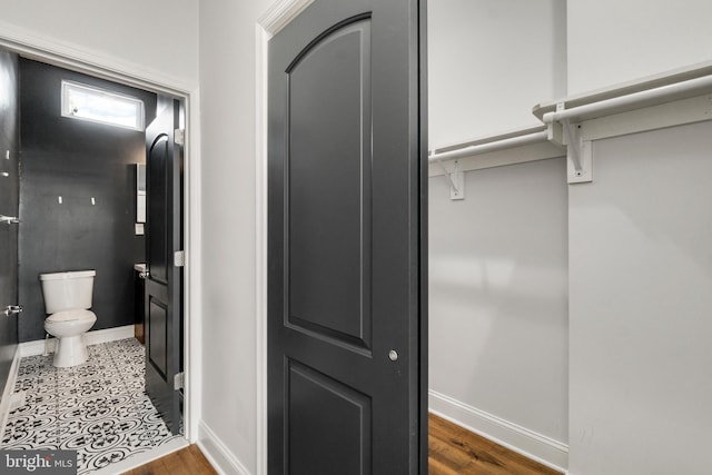 bathroom featuring toilet and tile flooring