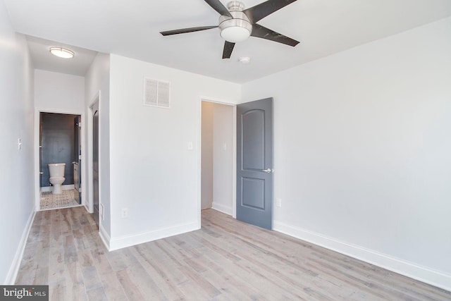 unfurnished bedroom with light hardwood / wood-style floors, ceiling fan, and ensuite bathroom