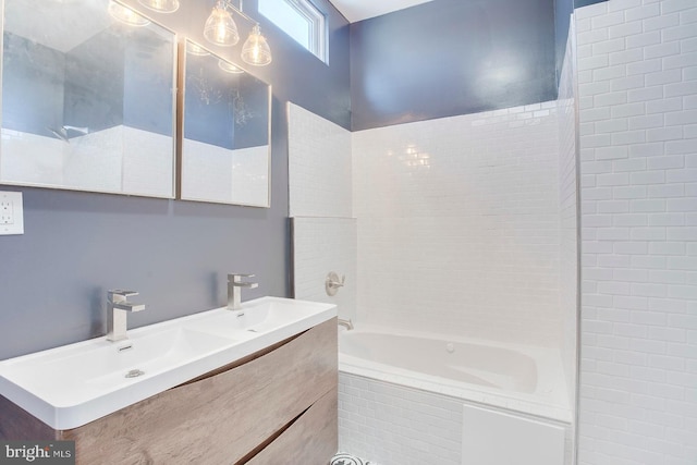 bathroom with tiled shower / bath combo and dual vanity