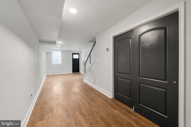 basement with hardwood / wood-style floors