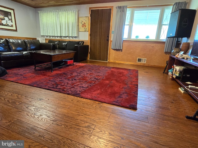 living room with crown molding and hardwood / wood-style flooring