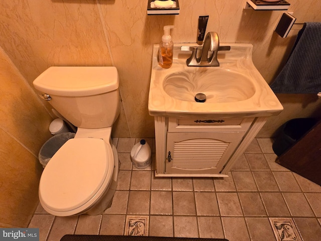 bathroom featuring vanity, toilet, and tile flooring