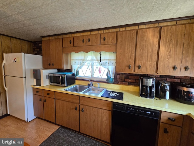 kitchen featuring light hardwood / wood-style flooring, white fridge, dishwasher, and sink