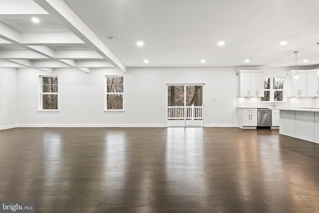 unfurnished living room with beamed ceiling, dark hardwood / wood-style flooring, sink, and coffered ceiling