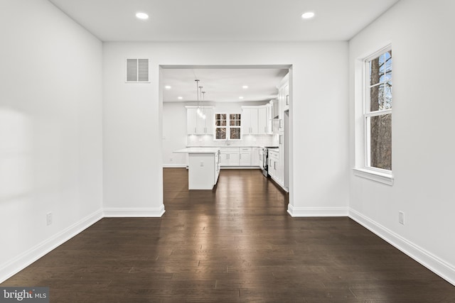 unfurnished living room featuring dark hardwood / wood-style flooring