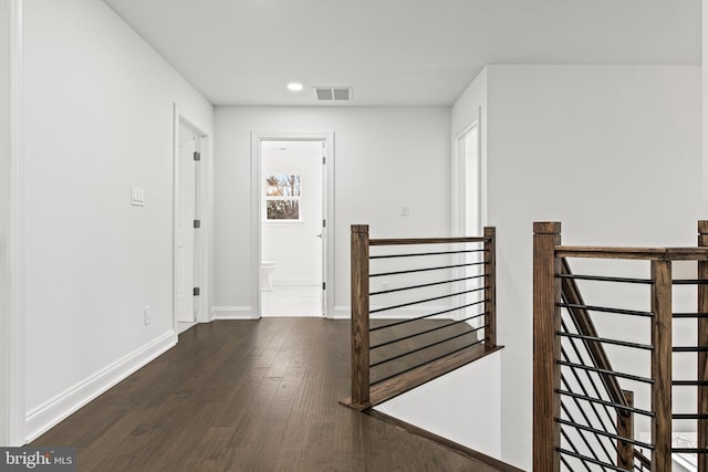 hall with dark wood-type flooring