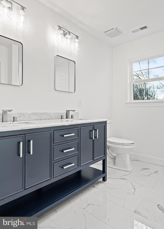 bathroom featuring vanity and toilet