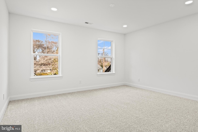 unfurnished room featuring carpet flooring and a healthy amount of sunlight