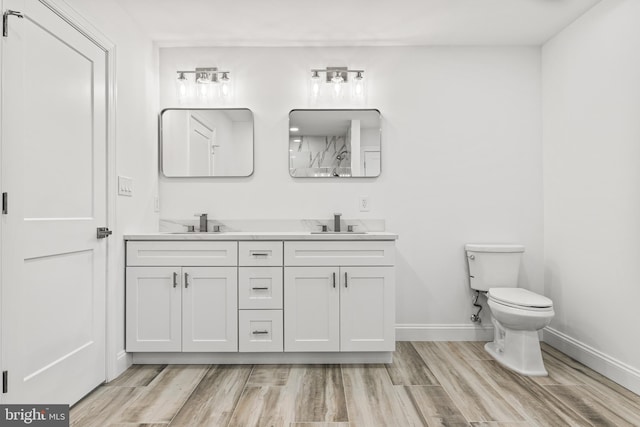 bathroom featuring vanity, toilet, and wood-type flooring