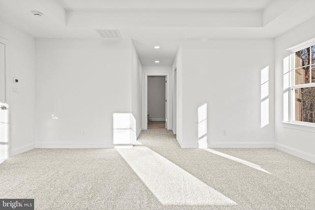 unfurnished room featuring light colored carpet