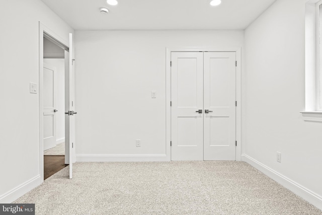 unfurnished bedroom featuring carpet and a closet