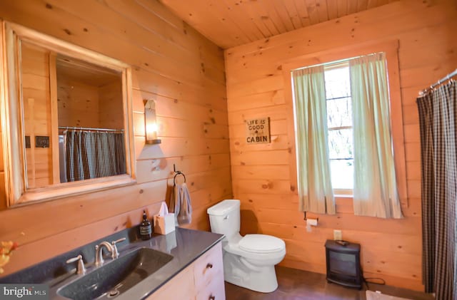 bathroom featuring vanity and wooden walls