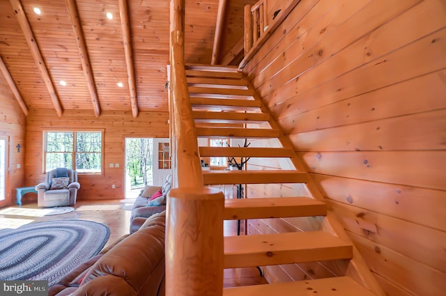 interior space with wood-type flooring, wood walls, wood ceiling, and vaulted ceiling with beams