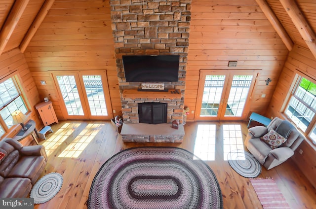 living room with beam ceiling, a healthy amount of sunlight, french doors, and high vaulted ceiling