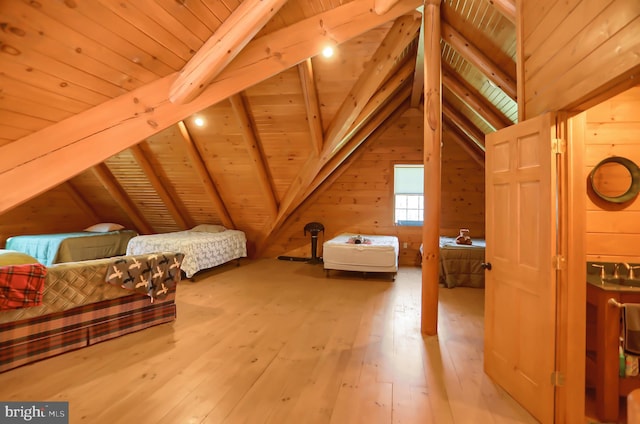 bonus room with vaulted ceiling with beams, wood ceiling, wooden walls, and light hardwood / wood-style floors