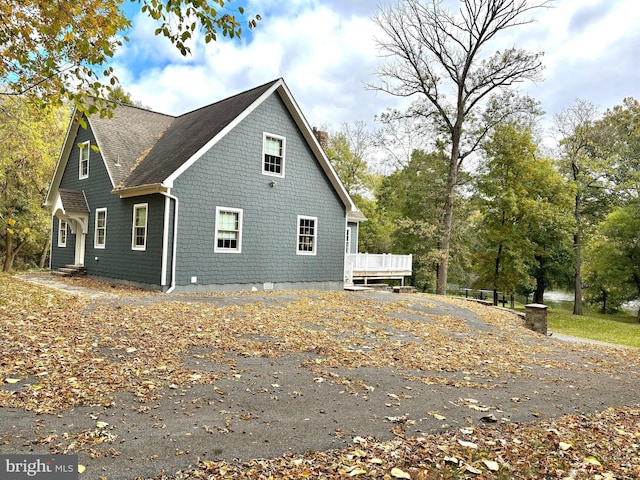 view of side of property featuring a wooden deck