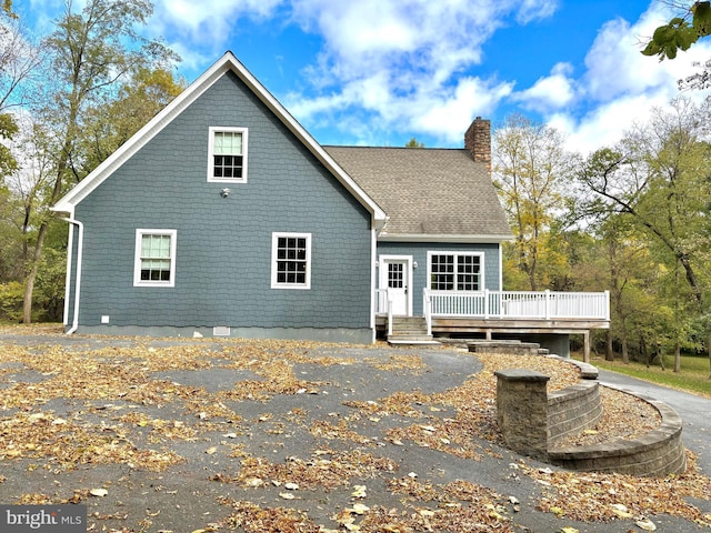 back of house with a wooden deck