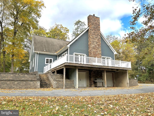 rear view of property featuring a deck