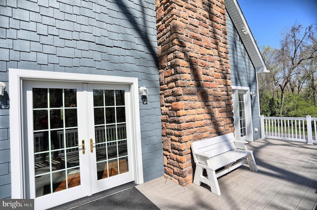 view of side of property featuring a wooden deck and french doors