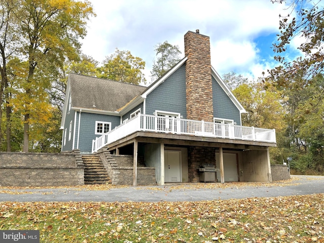 back of property featuring a wooden deck