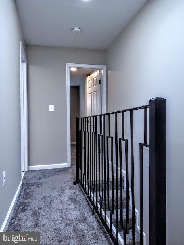 corridor with dark colored carpet