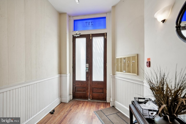 entryway with hardwood / wood-style floors and french doors