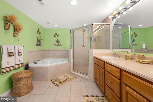 bathroom with tile patterned floors, vanity, and plus walk in shower