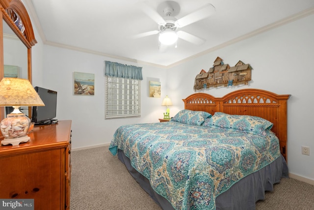 carpeted bedroom with ceiling fan and crown molding