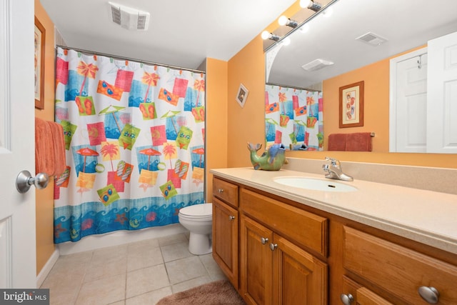 bathroom featuring tile patterned flooring, vanity, toilet, and walk in shower