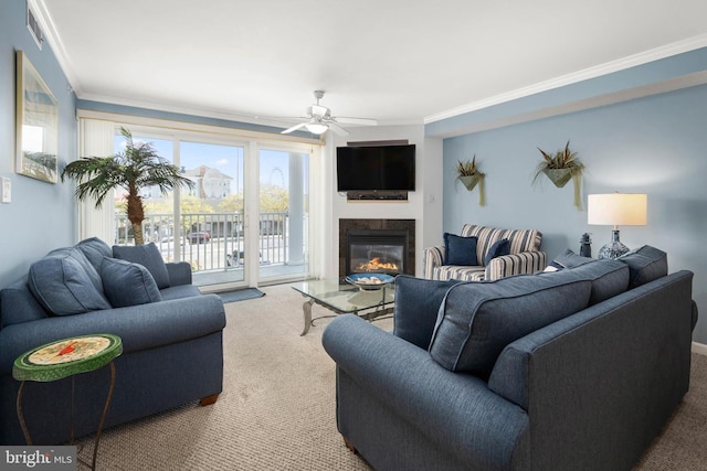 living room with carpet, ceiling fan, and crown molding