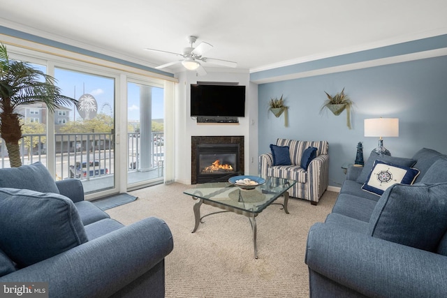 carpeted living room with ceiling fan and crown molding