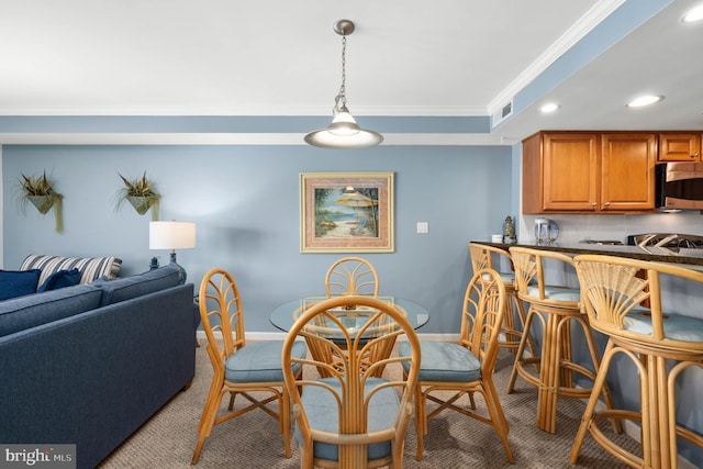 dining area with light carpet and ornamental molding