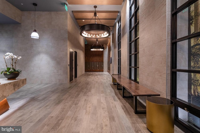 corridor with a high ceiling and hardwood / wood-style flooring