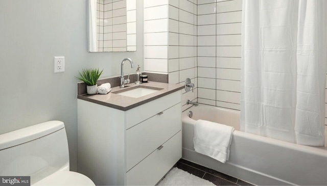 full bathroom featuring tile patterned floors, vanity, toilet, and shower / bath combo with shower curtain