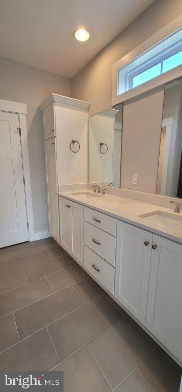 bathroom with tile floors and double sink vanity