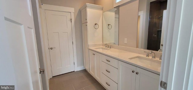 bathroom featuring tile flooring, oversized vanity, and double sink